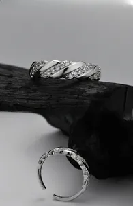 Macro detail of S925 sterling silver twisted geometric ring with zircon stones