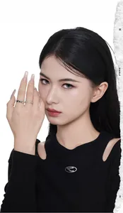 Detail of stacked S925 silver rings with rock texture and zircon pavé on model finger