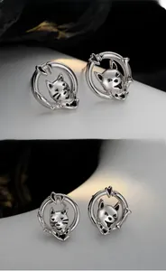 Macro detail of S925 sterling silver cat stud earrings with hollow circular design
