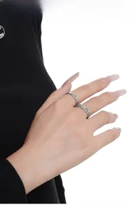 Detail of S925 sterling silver butterfly rings with blue enamel on model's hand