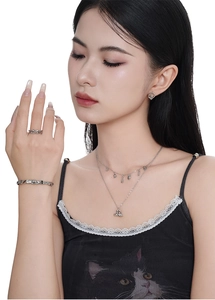 Close-up of S925 sterling silver jewelry set including boot pendant and heart earrings