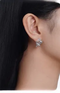 Detailed view of spider-shaped S925 silver stud earring on model with translucent hoop