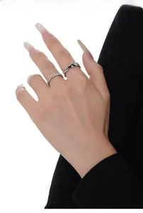 Close-up of S925 sterling silver snake rings with diamond-set waves and enamel rabbit details