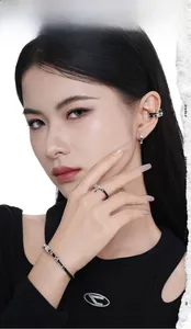 Close-up of S925 silver irregular earrings and cross jewelry set on a female model