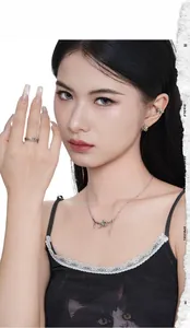 Silver punk style jewelry set featuring thorn ring and spiked pendant on female model