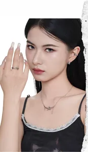Close-up of S925 sterling silver dark cat ear clip and thorn necklace set on model