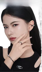 Detail showing S925 sterling silver earrings and leather cord ring set on a model