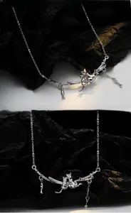 Detailed view of silver S925 cat and dog necklace with fish and bone charms on branch