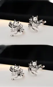 Detail of vintage sterling silver cat and dog ear clips with 3D animal sculpture