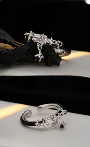 Detail of S925 sterling silver ring with black leather, cross carving and gemstone pendant