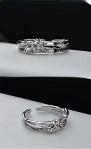 Detail of silver double-layered open ring with cat motif and bamboo texture