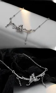 Detail of S925 silver necklace showing cats on a branch with fish and bone charms