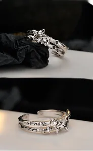 Macro shot of S925 silver ring detailing retro cat motifs and star sun engravings
