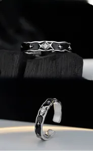 Detail of adjustable S925 silver star ring with black enamel and a central zircon stone