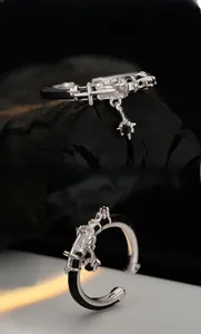 Macro shot of S925 silver ring with black leather texture and cross charm detail
