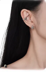 Detail of S925 sterling silver cat earrings and ear cuff on a female model ear