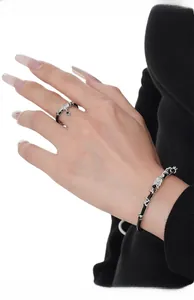 Detail of S925 sterling silver ring and black chain bracelet set on model hand