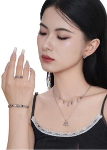 Macro shot of silver plated Sanrio cat style jewelry set worn by elegant female model
