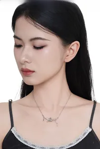 Detail of S925 sterling silver necklace featuring two cats sitting on a branch pendant