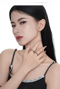 Close-up of S925 sterling silver rings with gothic thorn textures worn by a model