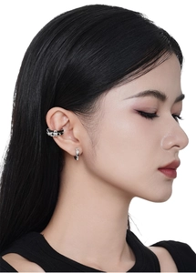 Detail of S925 silver ear cuff and stud set with black leather and sparkling zircon