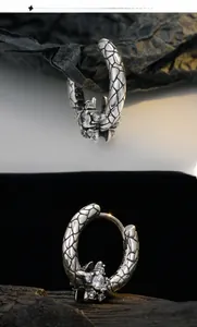 Macro view of vintage silver S925 snake skin texture earrings with sparkling zircon