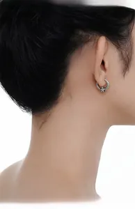 Detailed view of silver S925 earrings with crackle texture and sparkling star inlay