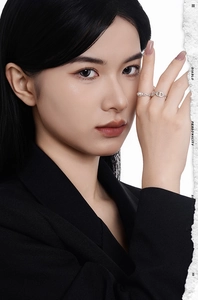 Detail view of S925 silver chain ring with pearl accent on model wearing black suit