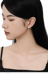 Close-up of S925 silver blue butterfly earrings with crystals on a female model