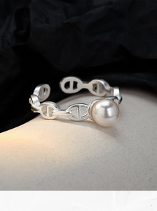 Detailed macro view of S925 sterling silver chain ring with white shell pearl inlay