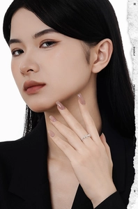 Detailed view of an S925 sterling silver cross ring worn by a model in a formal suit