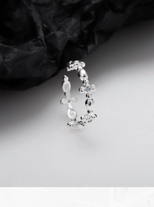 Close-up of S925 sterling silver open ring with light blue zircon floral cross patterns