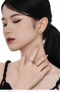 Close-up of model wearing star-shaped S925 sterling silver earrings and matching rings