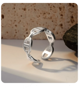 Macro shot of silver anchor chain ring showing smooth metallic finish and adjustable open band