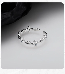 Macro shot of S925 sterling silver stamp and blue zircon stars on adjustable ring