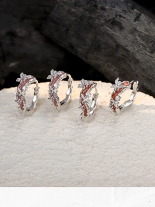 Close-up of S925 sterling silver hoop earrings with floral enamel and micro-inlaid stones