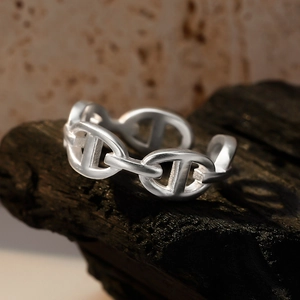 S925 sterling silver chain link open ring with matte finish on volcanic rock base