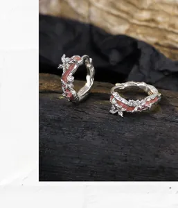 Detail of S925 silver irregular coral texture earrings with pink enamel and zircons
