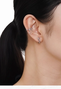 Close-up of S925 sterling silver ear cuff with chain and purple star gemstones on ear