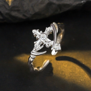 Gothic style S925 sterling silver cross ring with sparkling zircon on black rock surface
