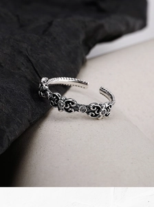 Macro shot of S925 sterling silver ring with Gothic floral carvings and black zircons