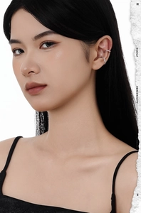Close-up of S925 sterling silver ear cuffs with twisted texture on a model's ear