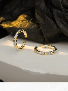Detail of S925 silver braided ear cuffs with two-tone gold plating and pavé zircon stones