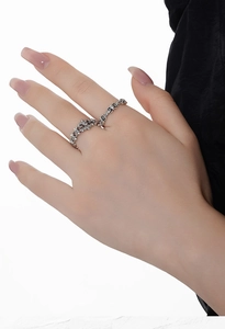 Detail of two vintage S925 silver rings with hollow gothic floral patterns on fingers