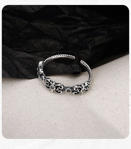 Macro detail of S925 sterling silver ring with black gemstones and vintage floral engraving