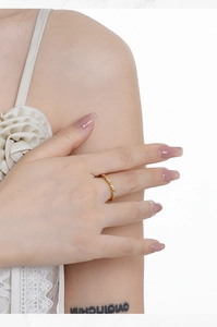 Close-up of twisted 18K gold ring with micro-pave white diamonds on model finger