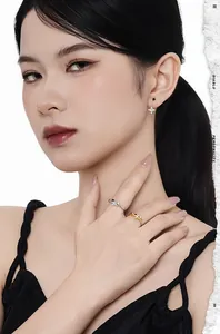 Detail of S925 silver star earrings and rings with cubic zirconia on model