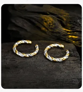 Detailed close-up of S925 silver rope-twist ear clips with dual-tone woven metal texture
