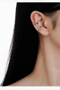 Detail of silver irregular ear cuffs with purple enamel on model ear set of two