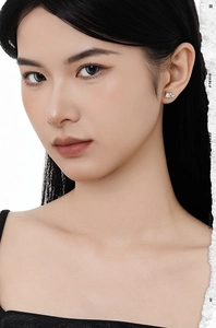 Close-up of star-shaped S925 silver stud earring with white agate stone on female model